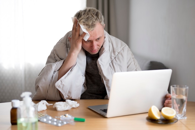 Sick man with fever staying indoors