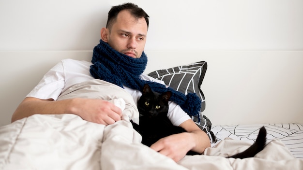 Sick person indoors with scarf