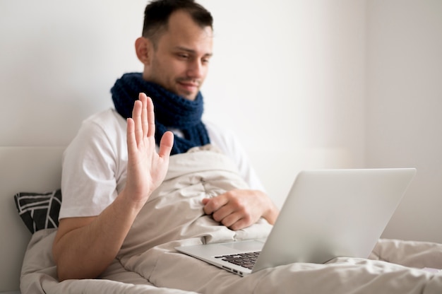 Sick person staying in bed and talks to his friends