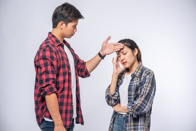 A sick woman had a man look and touch his forehead.