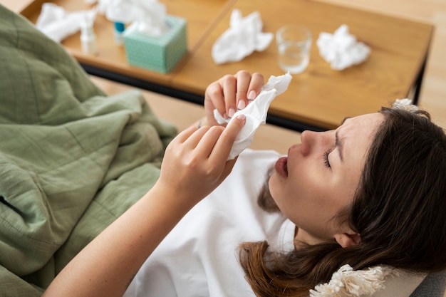 Free photo sick woman at home high angle