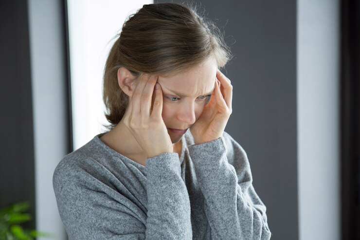 Free Photo sick woman at home massaging temples, feeling strong headache