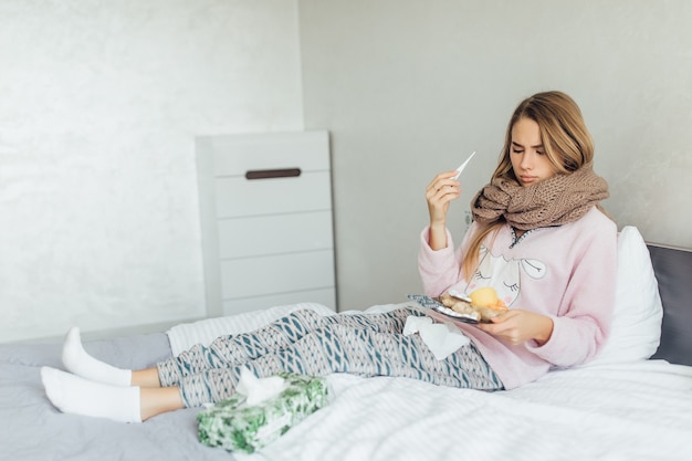 高熱とインフルエンザでベッドに横たわっている病気の女性