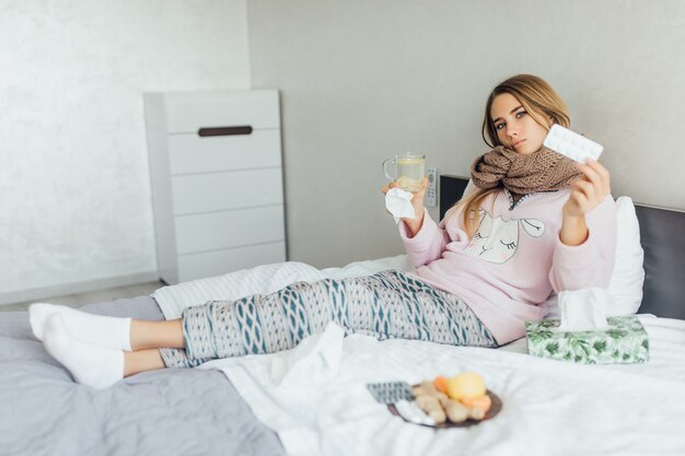 Sick woman lying in bed with high fever