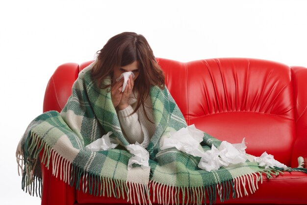 Sick woman surrounded by tissues