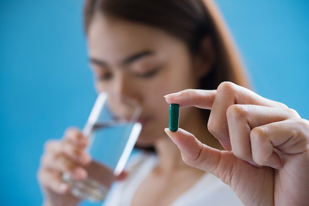 sick woman taking medicine