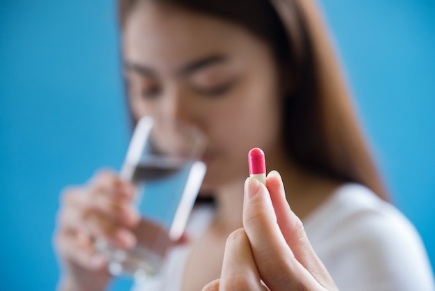 sick woman taking medicine