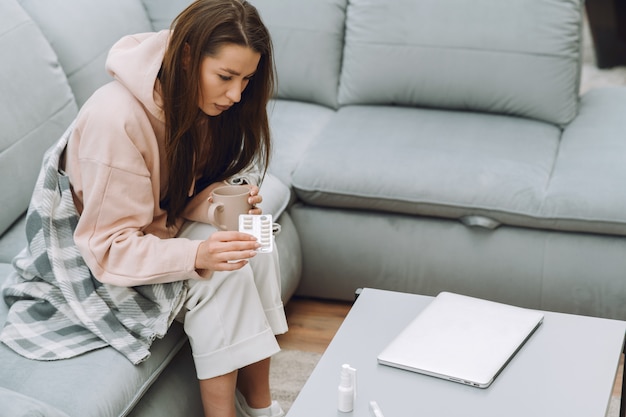 Free photo sick woman with headache sitting at home