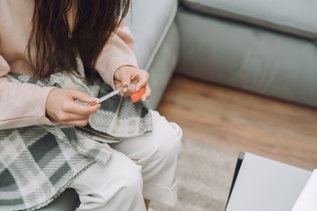 Sick woman with headache sitting at home