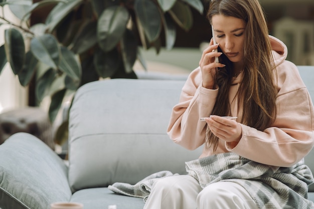 Sick woman with headache sitting at home