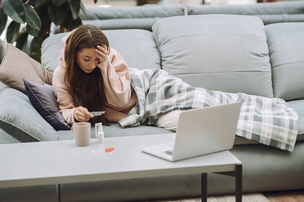 Sick woman with headache sitting at home