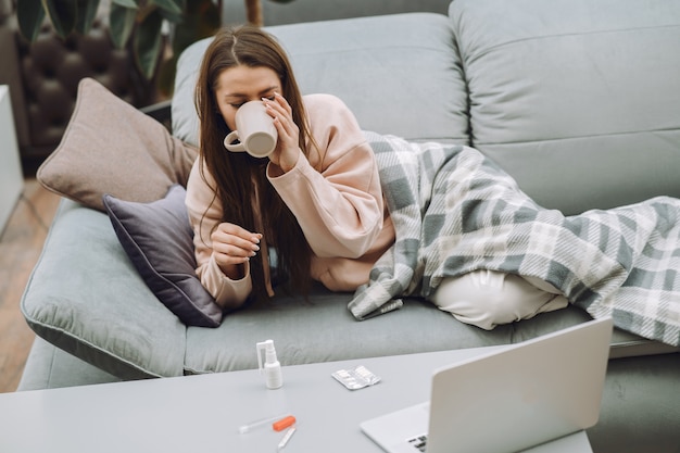 Sick woman with headache sitting at home