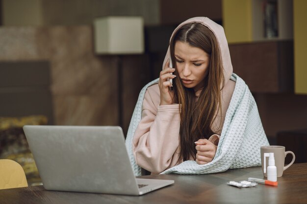 Sick woman with headache sitting at home