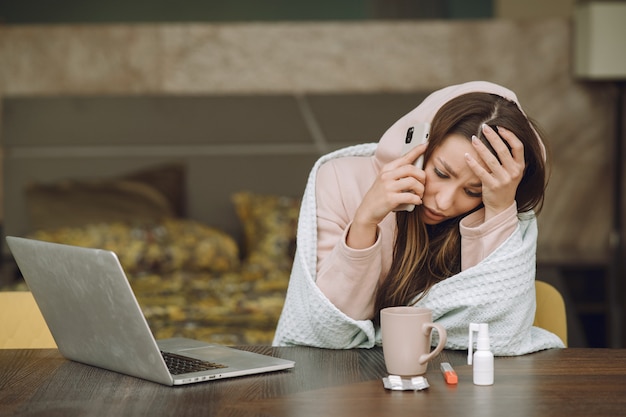 Sick woman with headache sitting at home