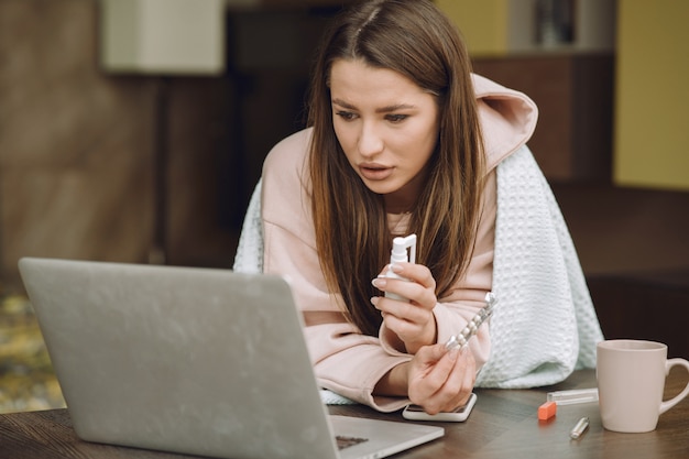 Sick woman with headache sitting at home