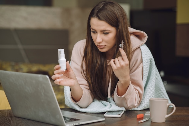 Sick woman with headache sitting at home