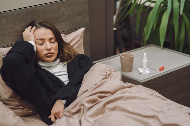sick woman with headache sitting at home