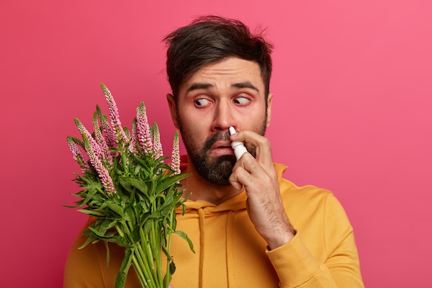 Free photo sick young man suffering from allergy isolated