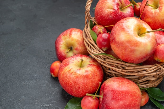 Side close-up view apples the appetizing fruits in the basket rope