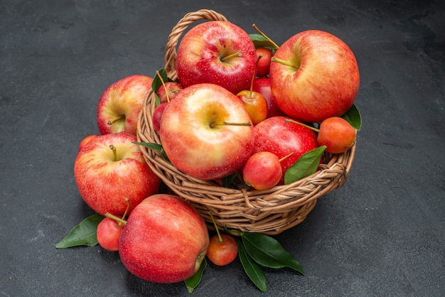 Side close-up view apples rope the appetizing fruits in the basket