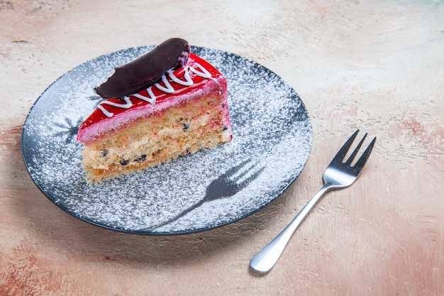 Side close-up view cake an appetizing cake with chocolate on the plate fork