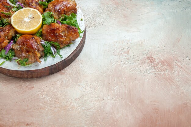 Side close-up view chicken lavash chicken onion lemon herbs on the wooden board