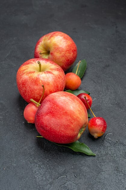 Side close-up view fruits the appetizing apples and berries with leaves