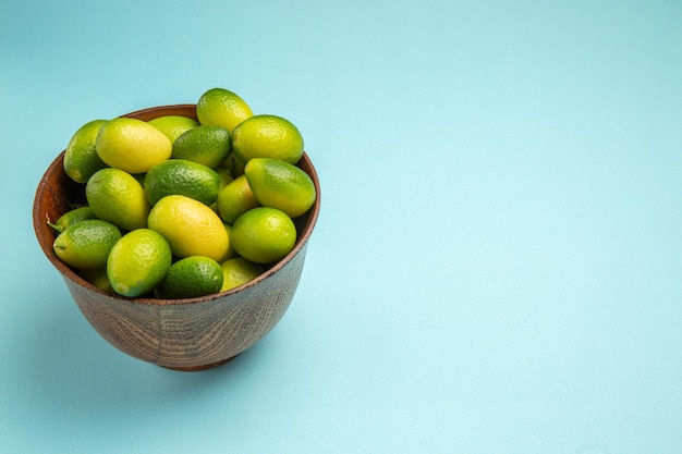 Side close-up view fruits the appetizing green fruits on the blue background