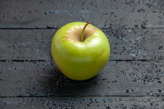 Side close-up view green apple appetizing green apple on dark background