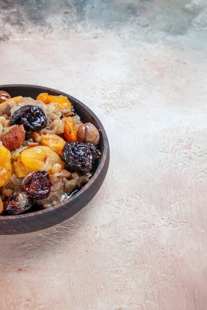 Side close-up view pilaf rice dried fruits chestnuts on the table