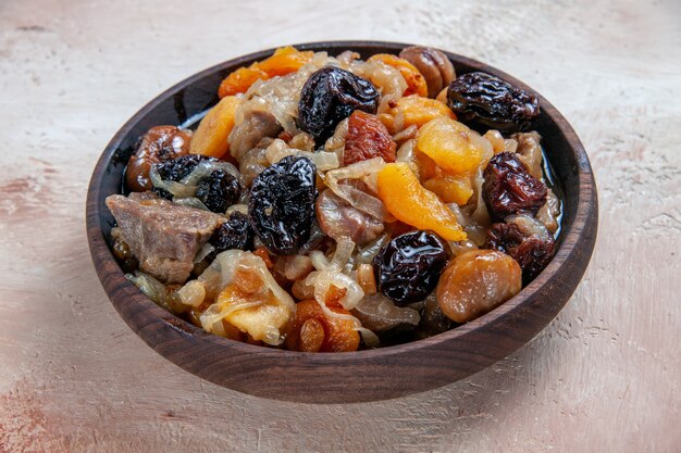 Side close-up view pilaf rice with dried fruits chestnuts on the table