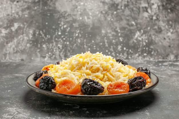 Side close-up view rice an appetizing rice with dried fruits in the plate