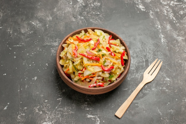 Side close-up view salad vegetable salad wooden fork