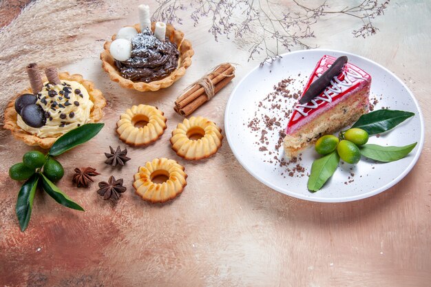 Side close-up view sweets a cake with chocolate cupcakes cookies citrus fruits cinnamon