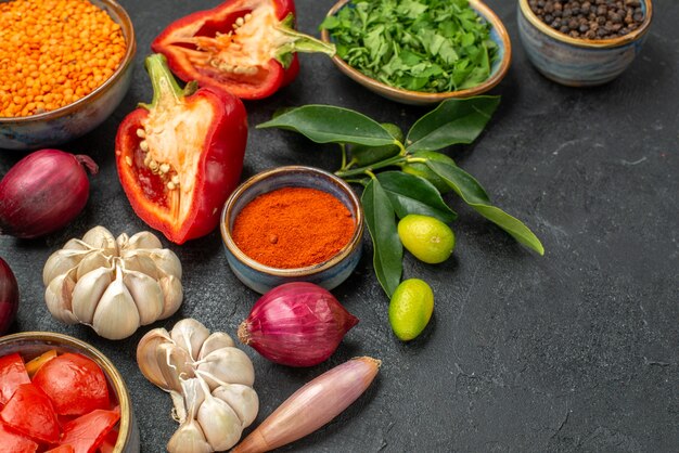 Side close-up view vegetables bowl of lentil herbs vegetables spices citrus fruits with leaves