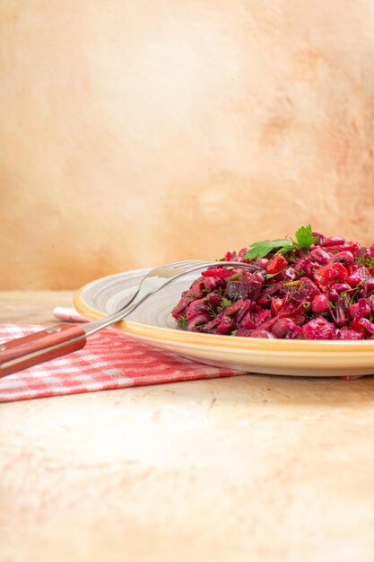 Side close view of plate of a red salad on a wooden backgorund