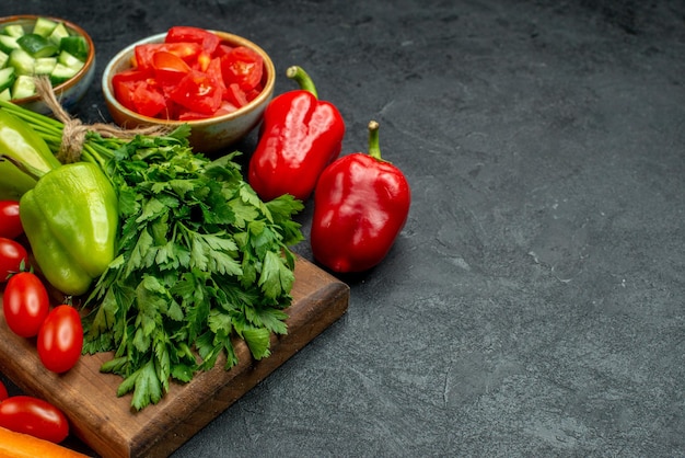 Side close view of plate stand with vegetables over and near to it on dark grey background