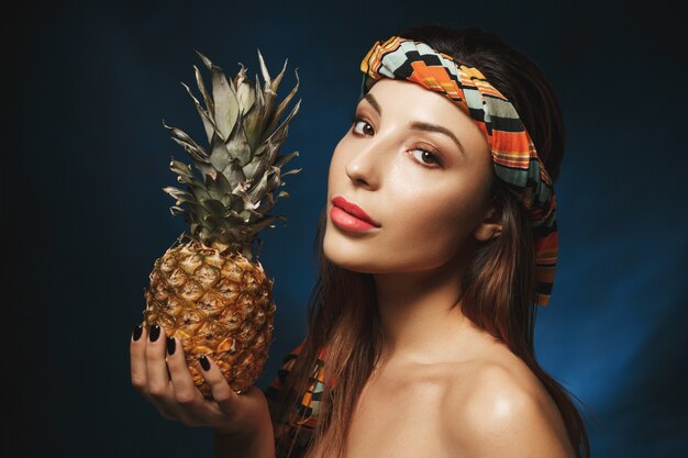 Side shot. Portrait of shirtless woman with striped durag. Beauty concept.