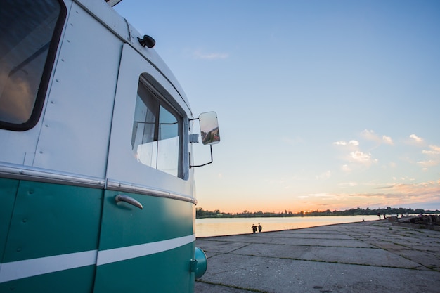 Side of a small Van parked near the beach