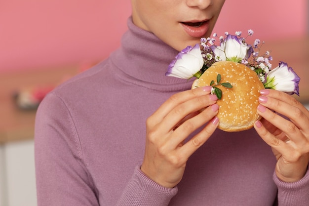 Free photo side view adult eating burger