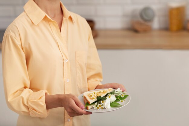 Free photo side view adult holding food plate