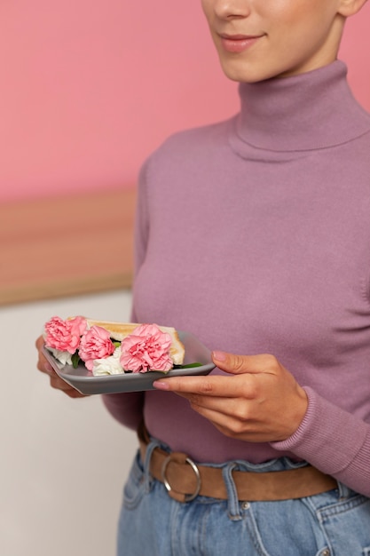 Free photo side view adult holding plate with food