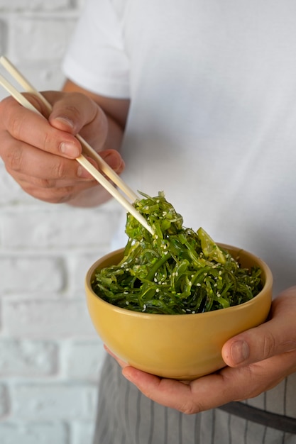 Side view adult holding seaweed meal