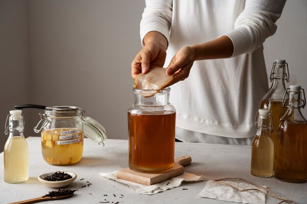 side view adult making kombucha