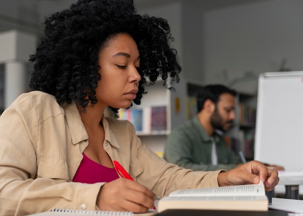 Free photo side view adults studying together