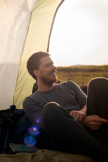 Side view adventurous man bivouacking