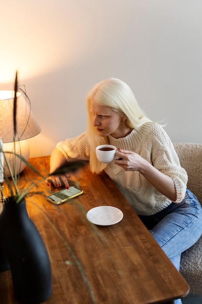 Side view albino woman sitting at table