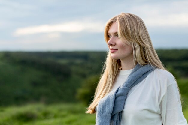 Side view of alluring woman in nature