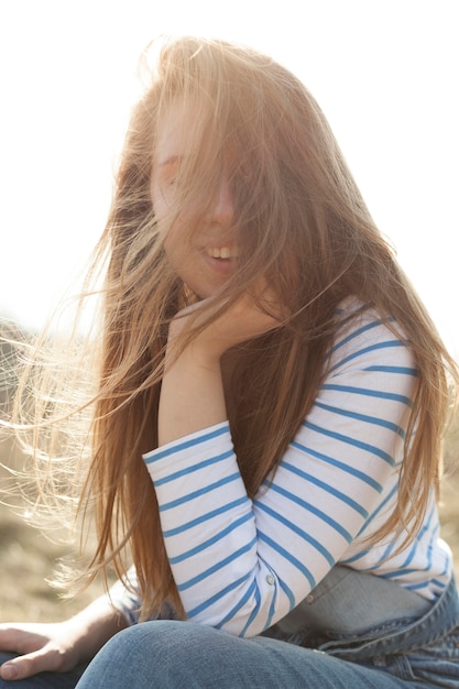 Side view of alluring woman posing outside in nature