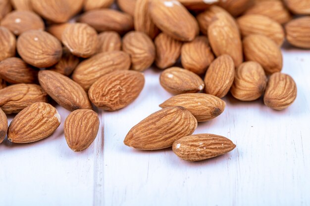 Side view of almond nuts on white background